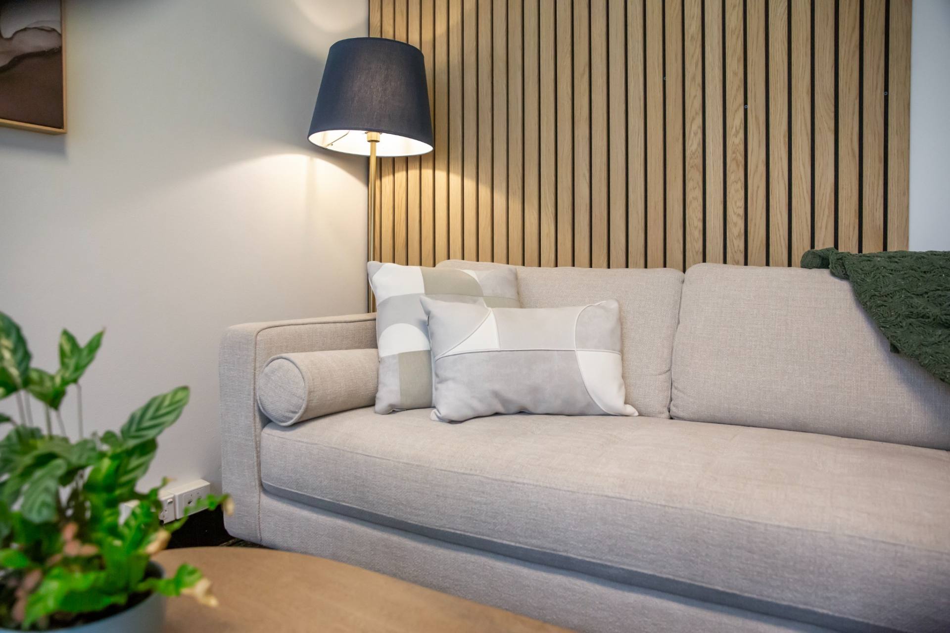 Counselling room at Southwell Counselling Greenslopes, Brisbane: sofa, cushions and warm lamp